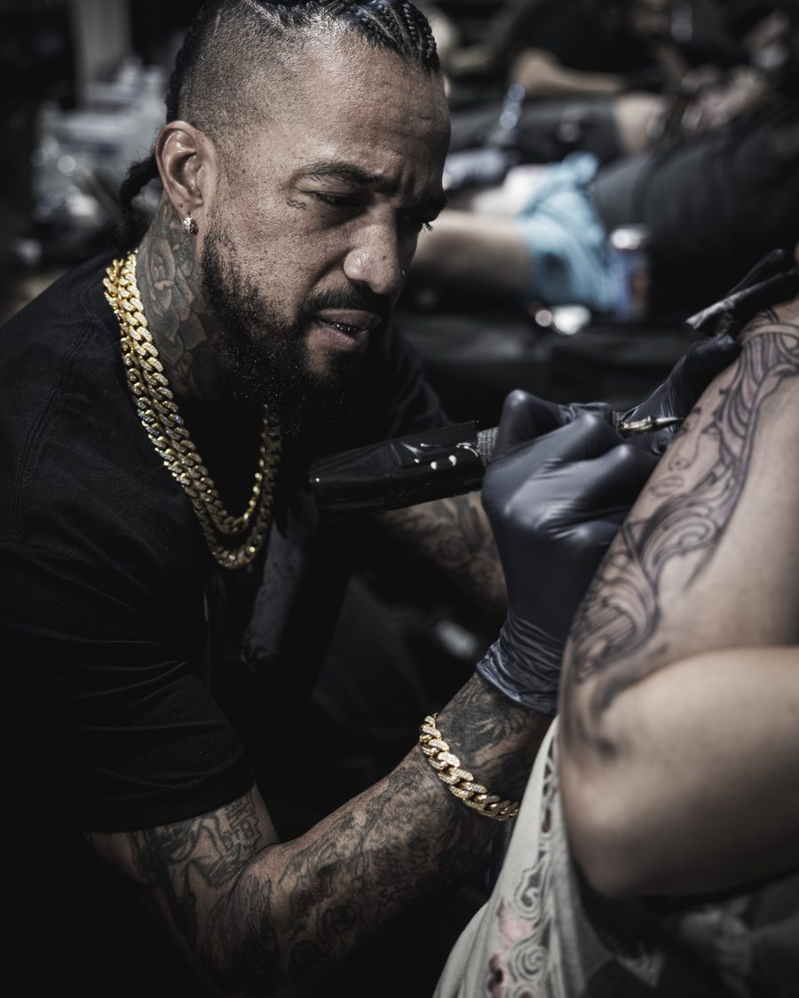Lifestyle documentary shot of a tattoo artist at work